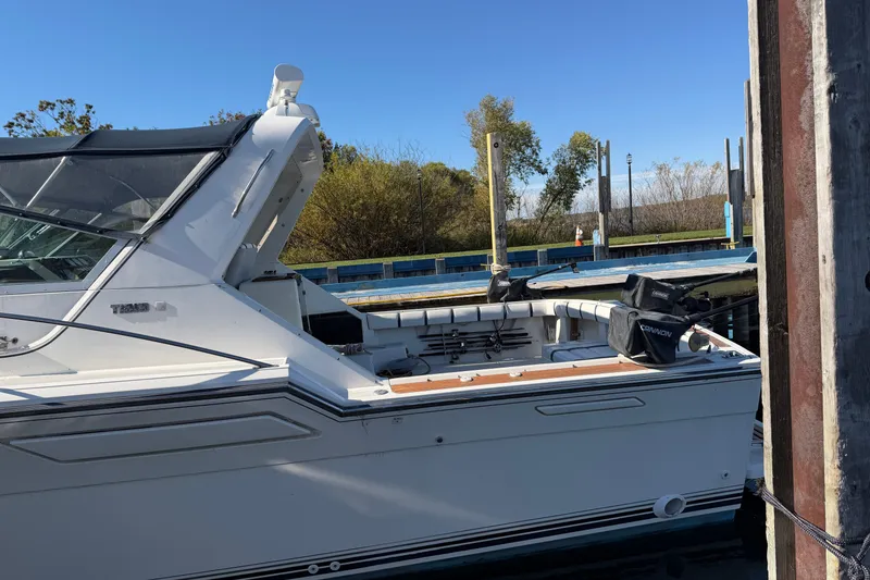 Slide: The Image of 1988 Tiara Yachts 3600 Open docked, featuring sleek design and spacious deck. - 9