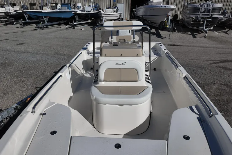 Slide: The Image of 2025 Bulls Bay 2000 boat with seating, parked in a marina with other boats. - 14
