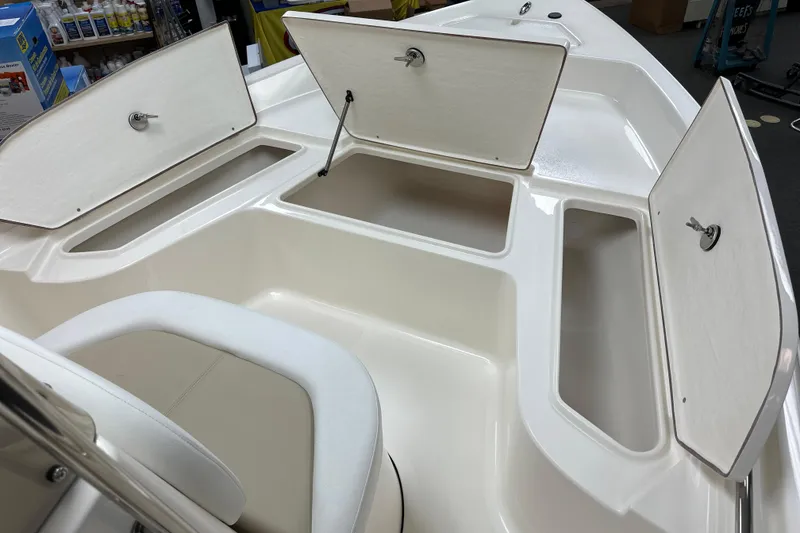 Slide: The Image of 2025 Bulls Bay 2000 boat interior with open storage compartments and seating. - 9