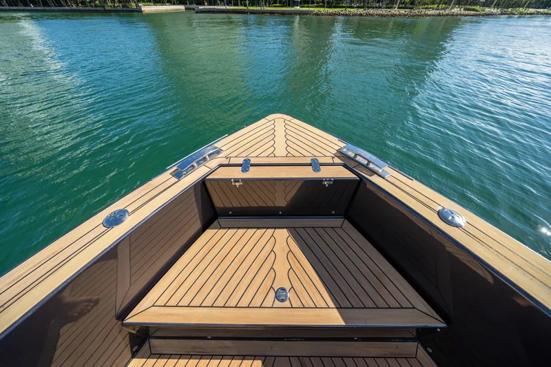 Slide: The Image of Bow view of 2023 Pardo Yachts 43 with sleek teak decking on calm water. - 21
