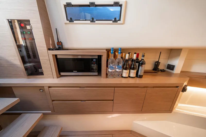 Slide: The Image of Modern kitchen area in 2023 Pardo Yachts 43 with microwave and wine bottles. - 24