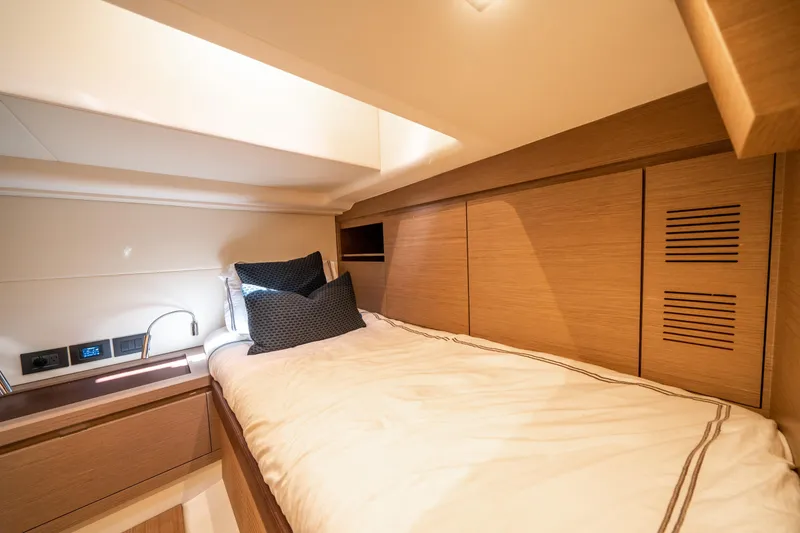 Slide: The Image of Luxurious cabin interior of 2023 Pardo Yachts 43, featuring modern wood finishes and cozy bedding. - 30