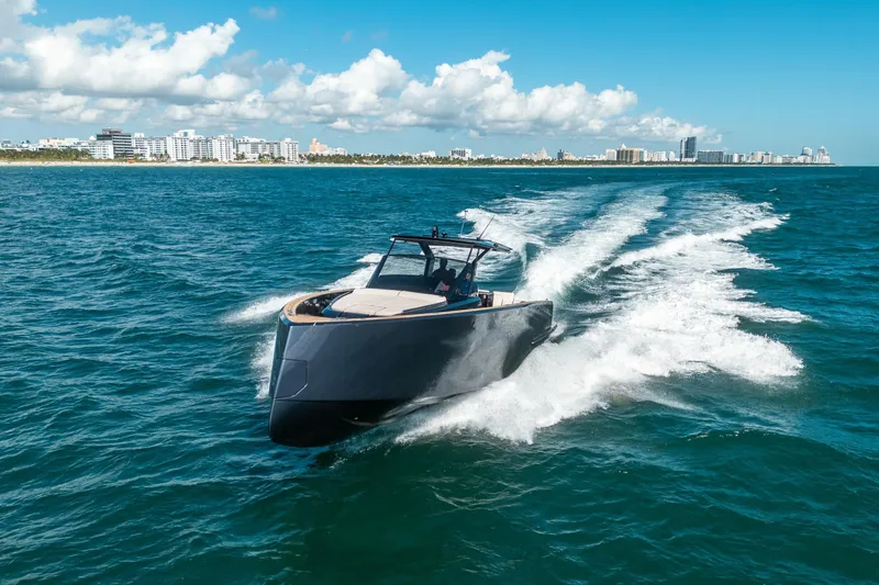 Slide: The Image of 2023 Pardo Yachts 43 cruising on ocean near city skyline under blue sky. - 31