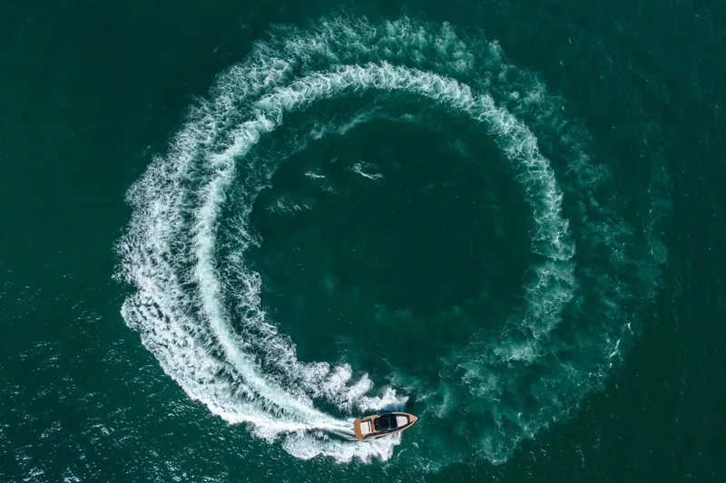 Slide: The Image of Aerial view of 2023 Pardo Yachts 43 creating circular wake in the ocean. - 36