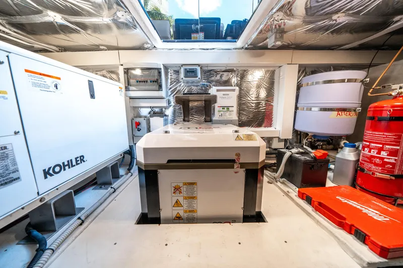 Slide: The Image of Engine room of 2023 Pardo Yachts 43, featuring Kohler generator and safety equipment. - 41