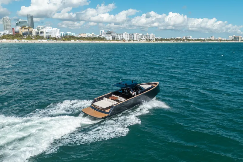 Slide: The Image of 2023 Pardo Yachts 43 cruising near a city coastline under a blue sky. - 6