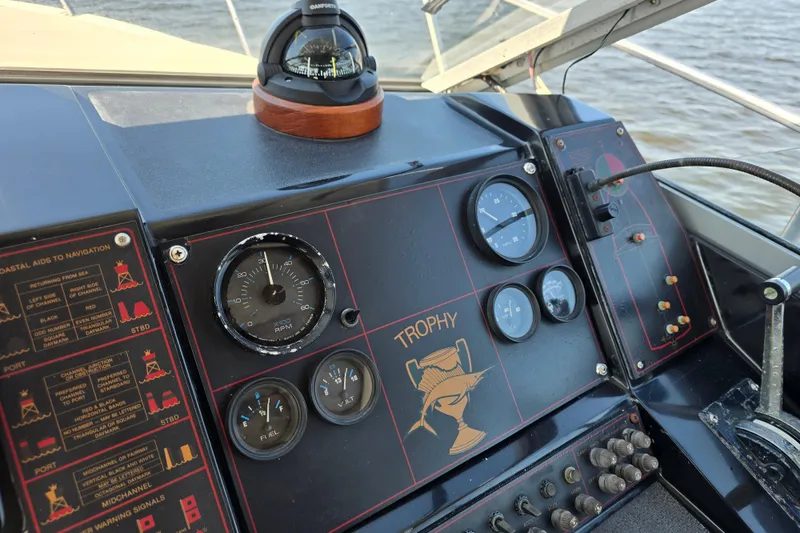 Slide: The Image of 1984 Bayliner 2802 Trophy boat dashboard with gauges and navigation aids. - 23