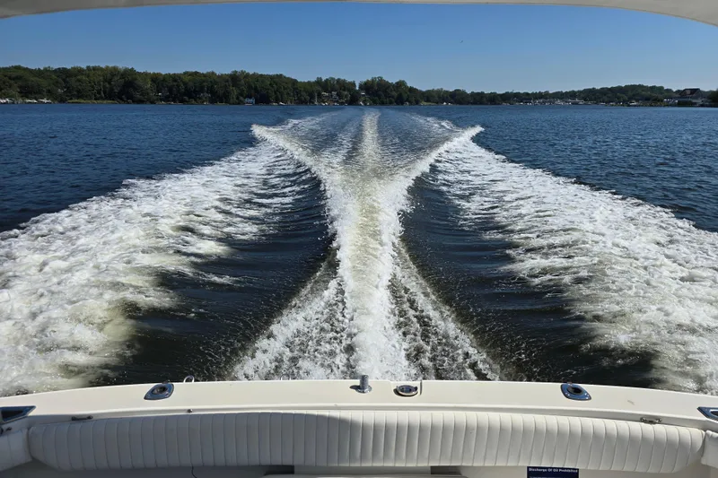Slide: The Image of Wake behind 1984 Bayliner 2802 Trophy boat on a sunny lake. - 26