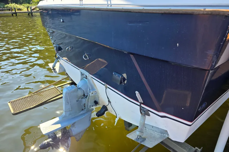 Slide: The Image of 1984 Bayliner 2802 Trophy boat stern with outboard motor in water. - 3