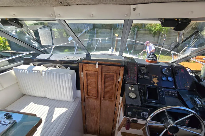 Slide: The Image of 1984 Bayliner 2802 Trophy boat interior with steering wheel and control panel. - 33