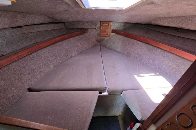 Slide: The Image of 1984 Bayliner 2802 Trophy cabin interior with cushioned seating and wooden accents. - 37