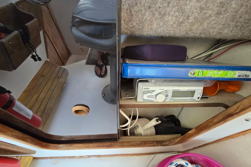 Slide: The Image of Interior of 1984 Bayliner 2802 Trophy boat with storage, seat, and fire extinguisher. - 42