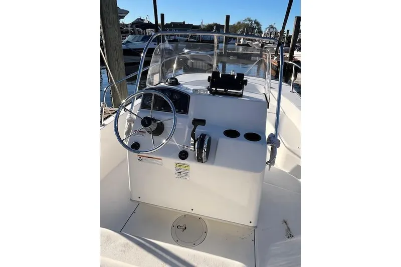 Slide: The Image of 2017 Boston Whaler 190 Montauk boat console with steering wheel and controls. - 10