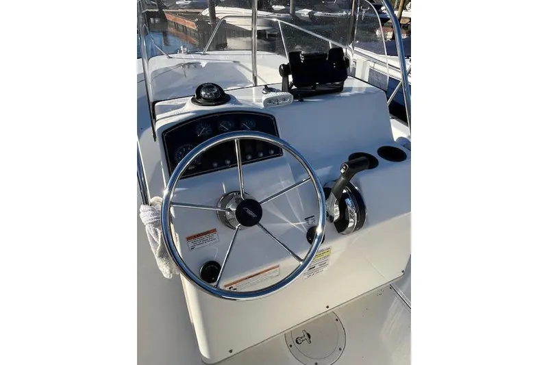 Slide: The Image of Steering console of a 2017 Boston Whaler 190 Montauk boat, featuring gauges and controls. - 11