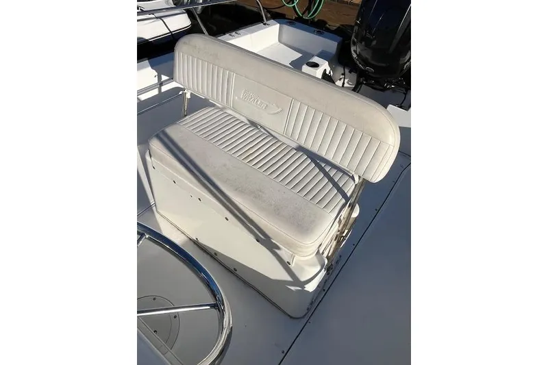Slide: The Image of 2017 Boston Whaler 190 Montauk boat seat, white upholstery, sleek design. - 12