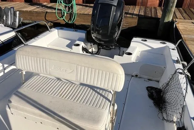 Slide: The Image of 2017 Boston Whaler 190 Montauk boat interior with seating and motor at dock. - 13