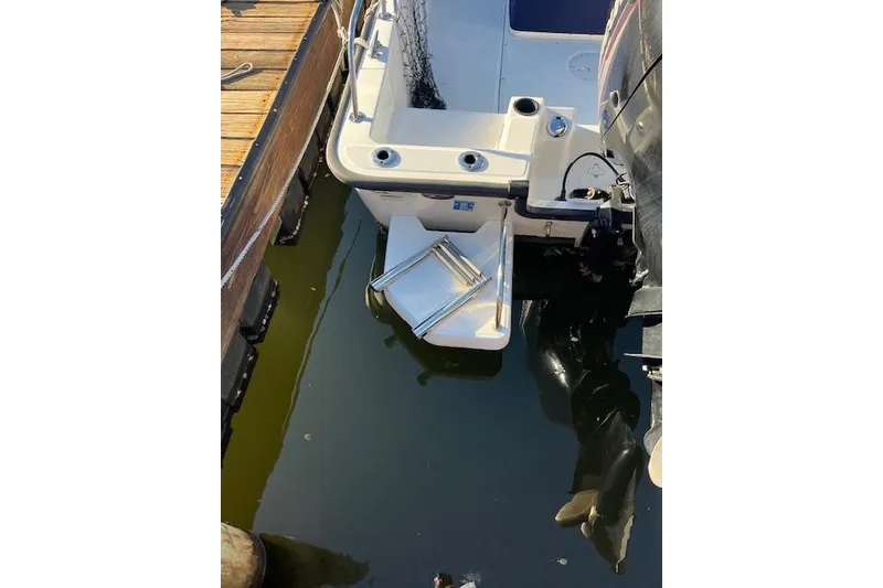 Slide: The Image of 2017 Boston Whaler 190 Montauk boat stern view at dock. - 4