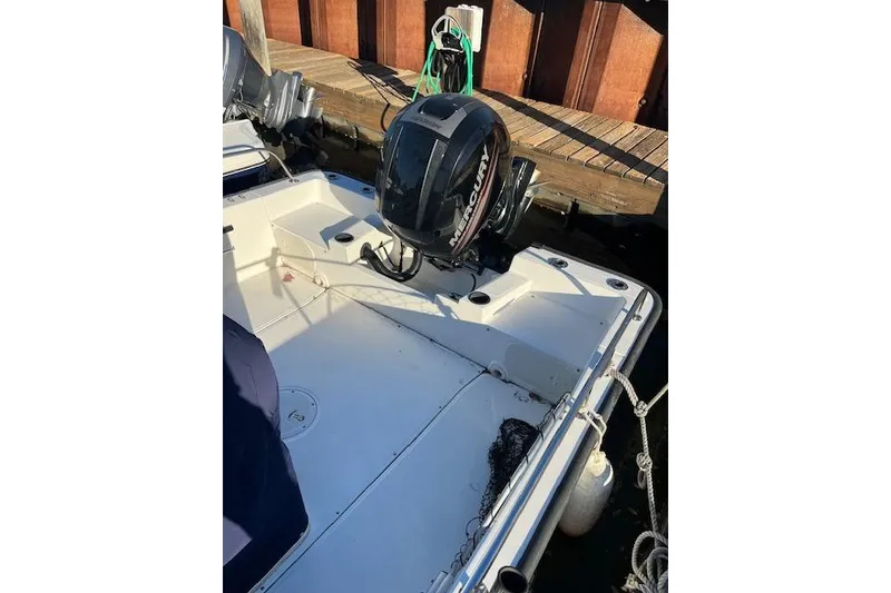 Slide: The Image of 2017 Boston Whaler 190 Montauk boat with Mercury outboard motor docked at marina. - 9