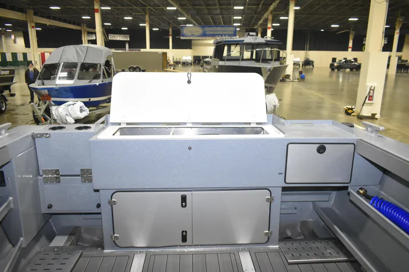 Slide: The Image of 2026 KingFisher 2825 Coastal Express interior with storage compartments and fishing setup. - 17