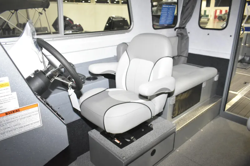 Slide: The Image of Interior of 2026 KingFisher 2825 Coastal Express boat, featuring a modern captain's seat. - 22