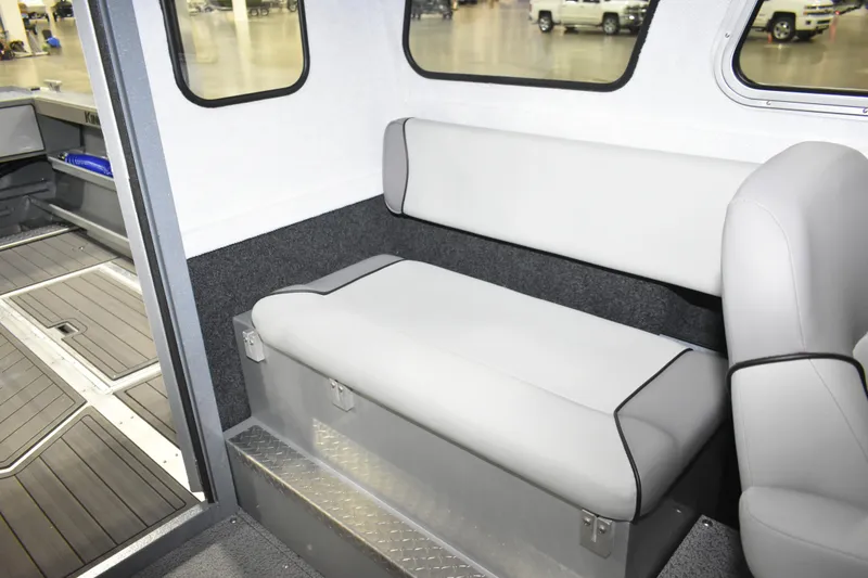 Slide: The Image of Interior of 2026 KingFisher 2825 Coastal Express boat with gray seating and windows. - 23