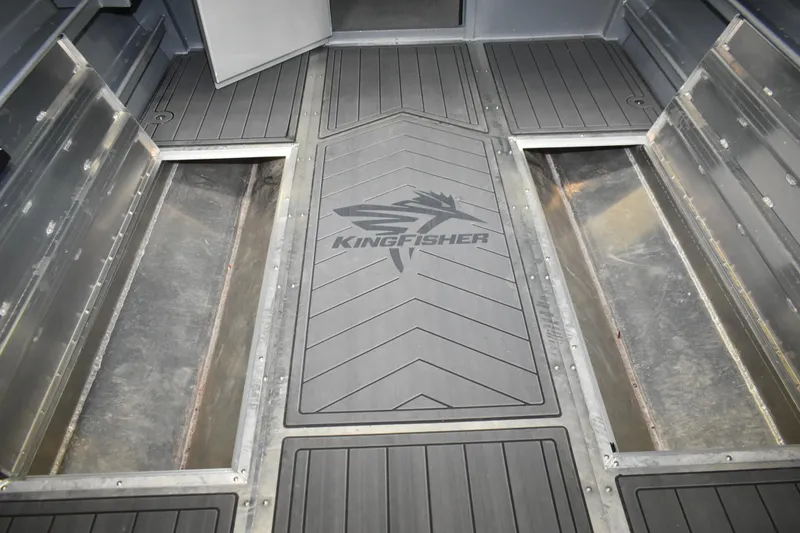 Slide: The Image of 2026 KingFisher 2825 Coastal Express boat interior with storage compartments and logo. - 28