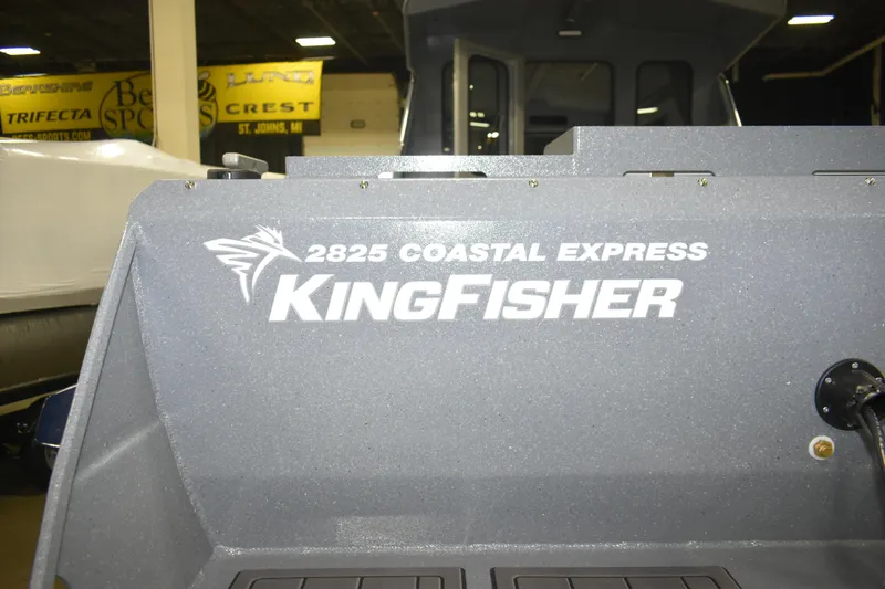 Slide: The Image of 2026 KingFisher 2825 Coastal Express boat interior with logo in showroom. - 29
