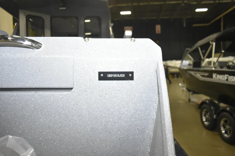 Slide: The Image of 2026 KingFisher 2825 Coastal Express boat in showroom, close-up of hull identification number. - 30