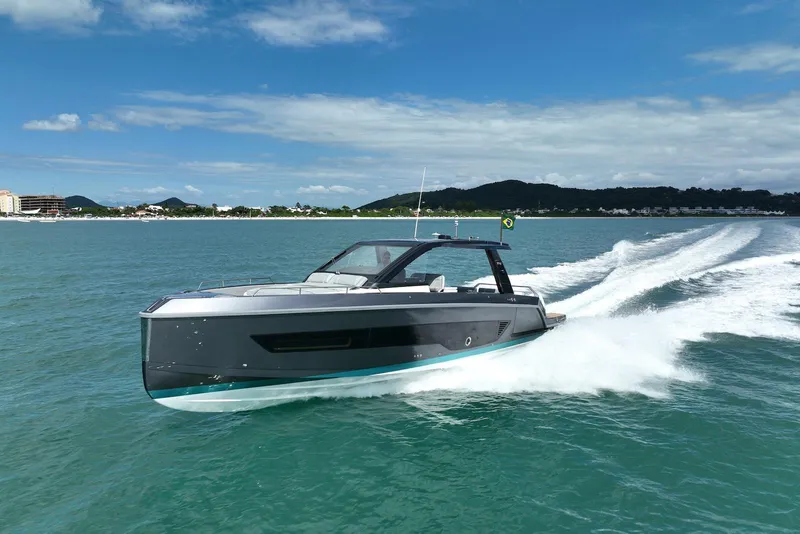 The Image of 2026 Schaefer Yachts V44 cruising on open water under a clear blue sky. - 1