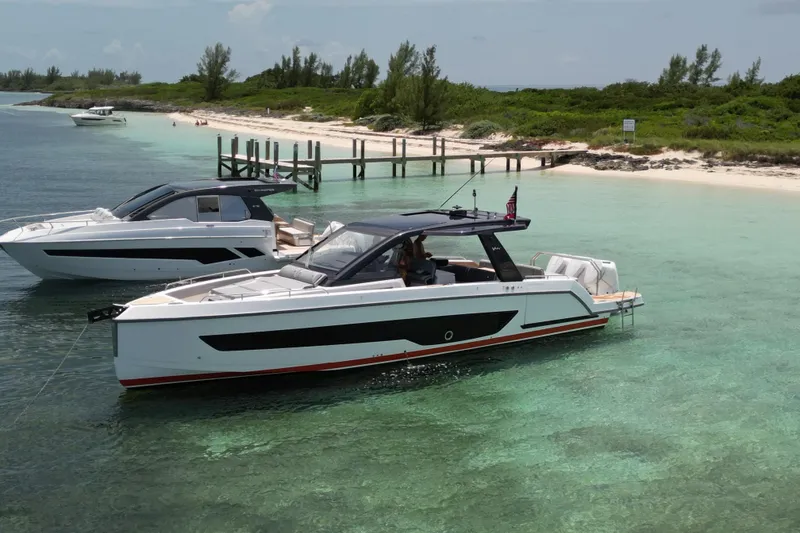 Slide: The Image of 2026 Schaefer Yachts V44 in clear turquoise waters near a sandy beach. - 13
