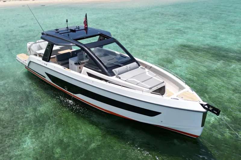 Slide: The Image of Schaefer Yachts V44 2026 model cruising in clear turquoise waters near a sandy beach. - 4