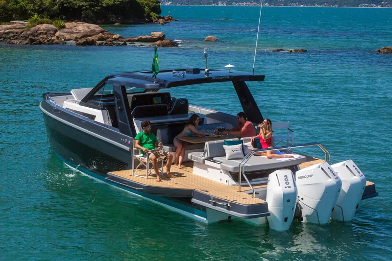 Slide: The Image of 2026 Schaefer Yachts V44 cruising on turquoise waters with passengers relaxing onboard. - 5