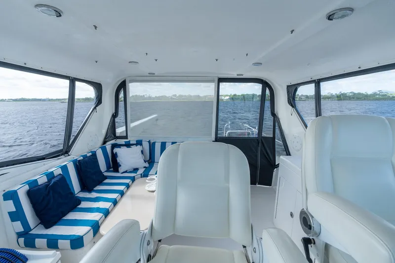 Slide: The Image of Interior of 2009 Pacific Mariner 65 Motoryacht with striped seating and water view. - 15