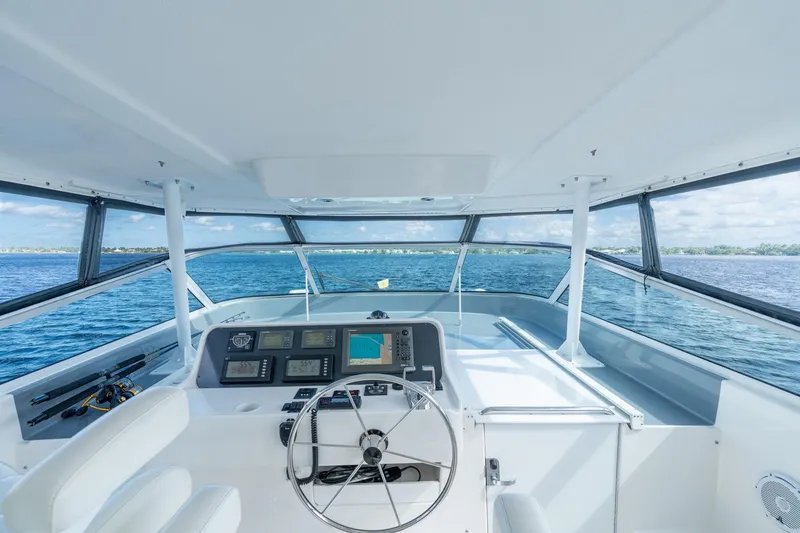 Slide: The Image of 2009 Pacific Mariner 65 Motoryacht helm with ocean view, featuring modern navigation equipment. - 17
