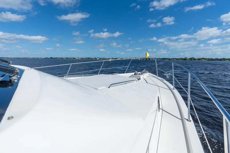 Slide: The Image of 2009 Pacific Mariner 65 Motoryacht cruising on open water under blue skies. - 19