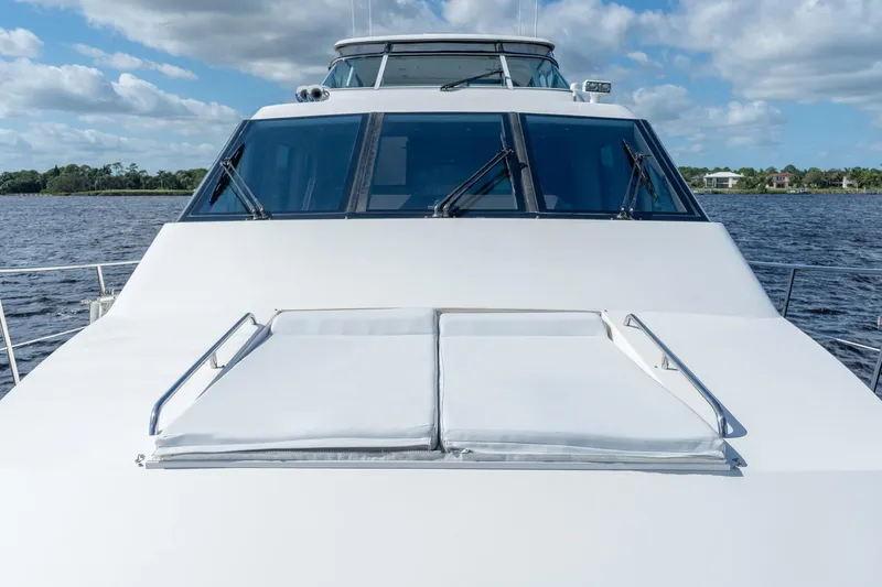 Slide: The Image of 2009 Pacific Mariner 65 Motoryacht on water, showcasing sleek design and spacious deck. - 20