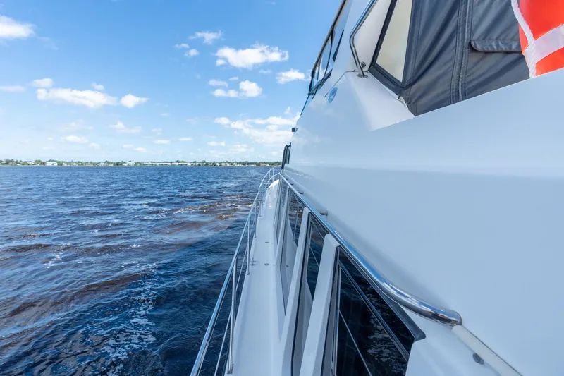 Slide: The Image of 2009 Pacific Mariner 65 Motoryacht cruising on a sunny day with clear blue skies. - 22