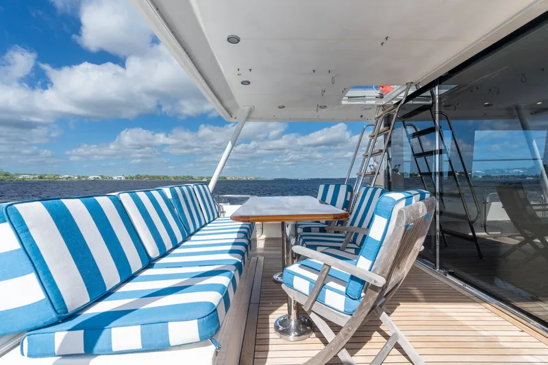 Slide: The Image of Luxurious 2009 Pacific Mariner 65 Motoryacht deck with striped seating and ocean view. - 28