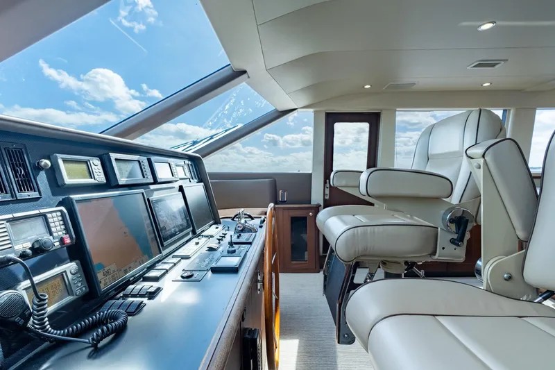 Slide: The Image of 2009 Pacific Mariner 65 Motoryacht helm with navigation equipment and luxurious seating. - 31