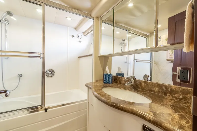 Slide: The Image of Luxurious bathroom in 2009 Pacific Mariner 65 Motoryacht with marble countertop and glass shower. - 46