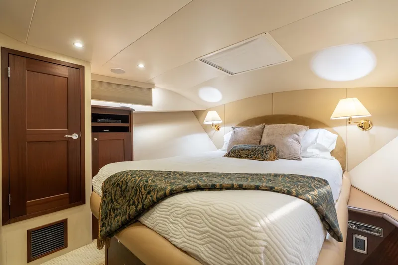 Slide: The Image of Luxurious bedroom interior of 2009 Pacific Mariner 65 Motoryacht with elegant bedding and warm lighting. - 49