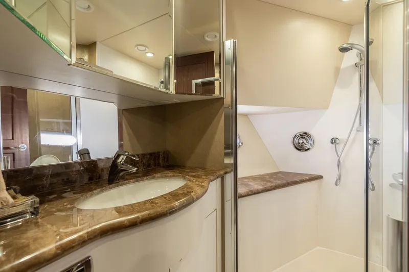 Slide: The Image of Luxurious bathroom in 2009 Pacific Mariner 65 Motoryacht with marble countertop and glass shower. - 51