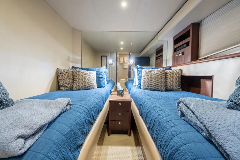Slide: The Image of Luxurious twin cabin in 2009 Pacific Mariner 65 Motoryacht with blue bedding and elegant decor. - 53