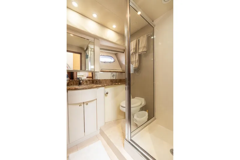 Slide: The Image of Luxurious bathroom in 2009 Pacific Mariner 65 Motoryacht with marble countertop and glass shower. - 56