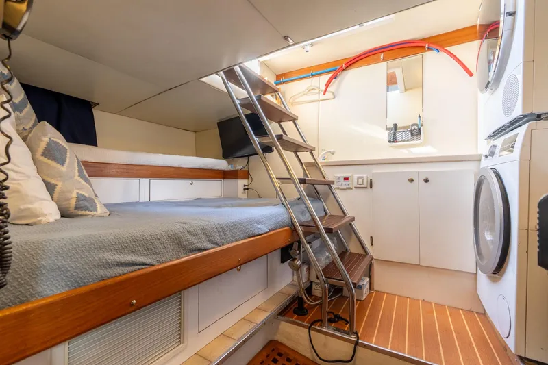 Slide: The Image of 2009 Pacific Mariner 65 Motoryacht interior with bunk bed, stairs, and laundry area. - 57
