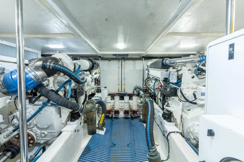 Slide: The Image of Engine room of 2009 Pacific Mariner 65 Motoryacht with dual engines and blue piping. - 58