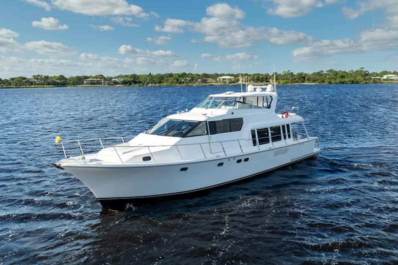 Slide: The Image of 2009 Pacific Mariner 65 Motoryacht cruising on a sunny day, surrounded by blue water. - 8