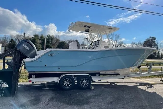 Slide: The Image of 2022 Sea Fox 288 Commander boat on trailer, featuring Yamaha engine, under clear blue sky. - 15