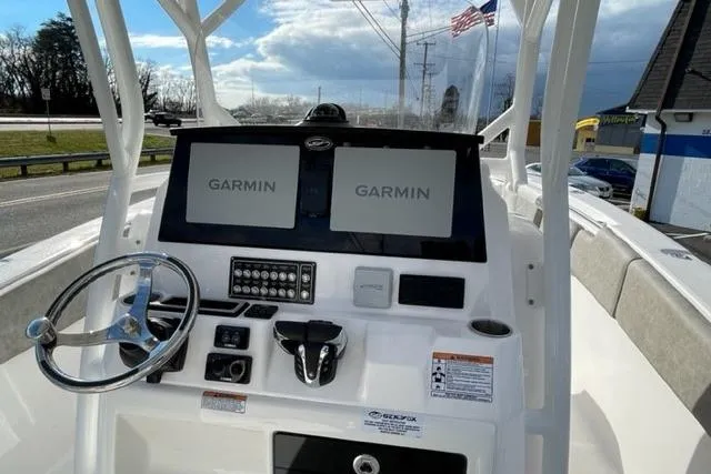 Slide: The Image of 2022 Sea Fox 288 Commander boat dashboard with dual Garmin displays and steering wheel. - 16