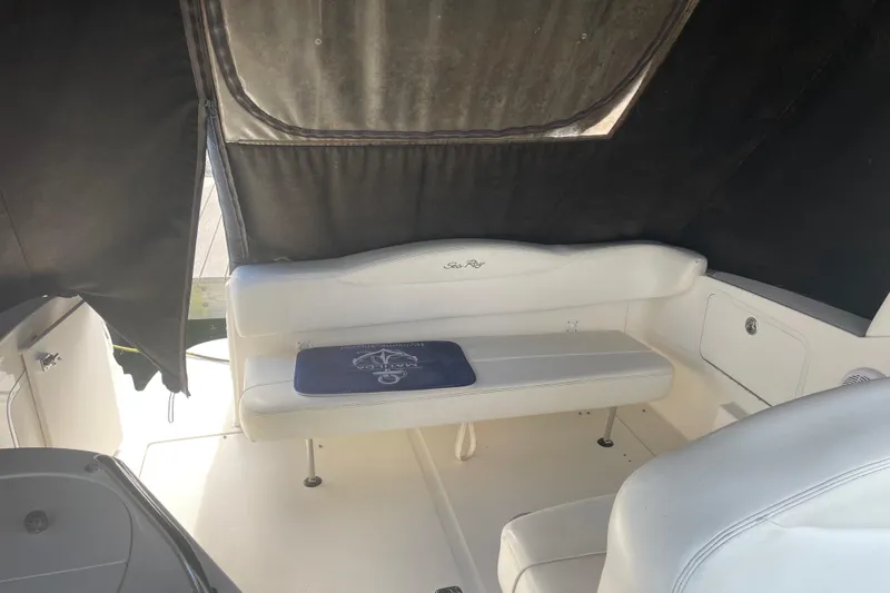 Slide: The Image of 2006 Sea Ray Sundancer 280 interior with white seating and black canopy. - 12